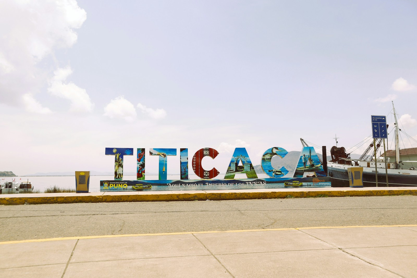 a large sign that says tica on the side of a road